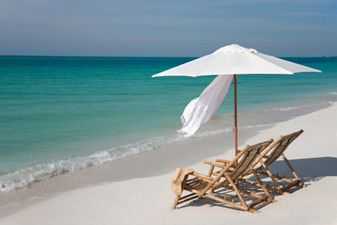 chairs and an umbrella on a beach